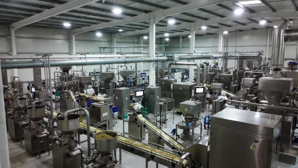 Spacious industrial facility with automated machinery and conveyor belts filling capsules in a kratom processing plant