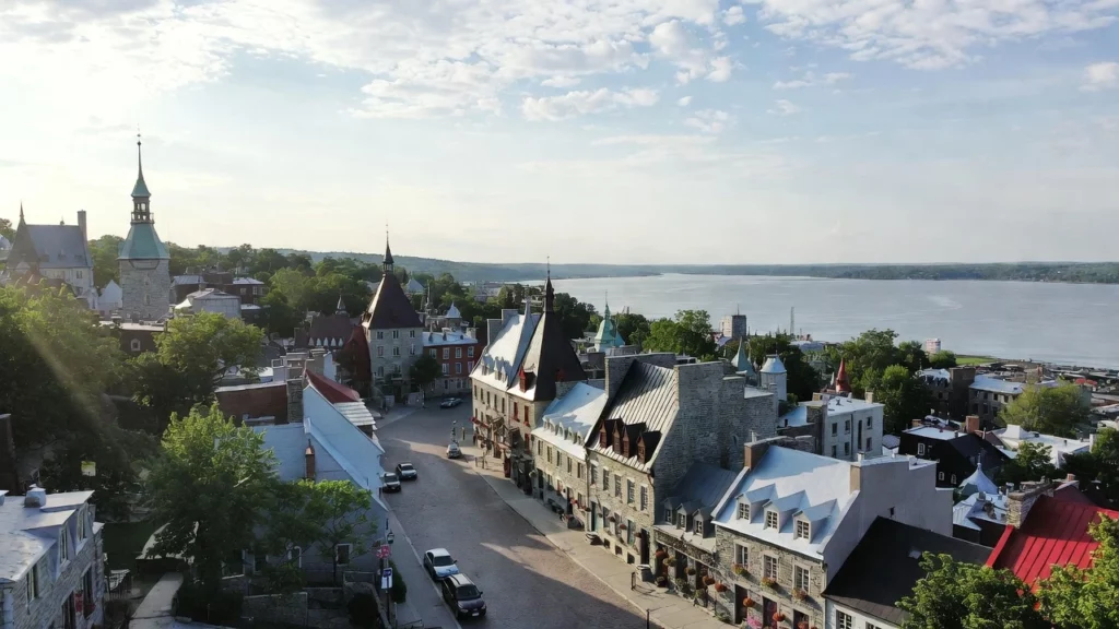A historic Old Quebec neighbourhood with stone buildings, church spires, and St. Lawrence River waterfront in Quebec City